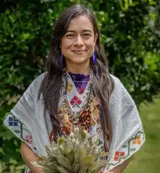 lead female shaman at Harmonica Retreat vanessa delgado standing in the nature with her Waira