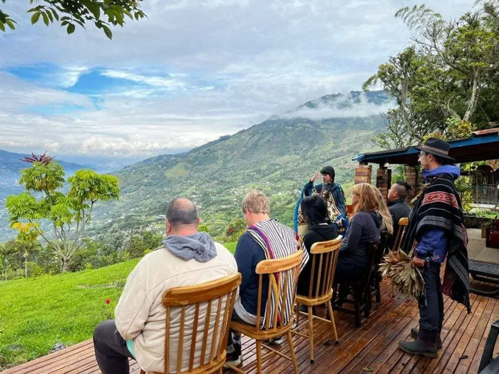 Harmonica Ayahuasca Retreat Colombia Gathering above the valley Participants gathered in a circle on the deck above the valley