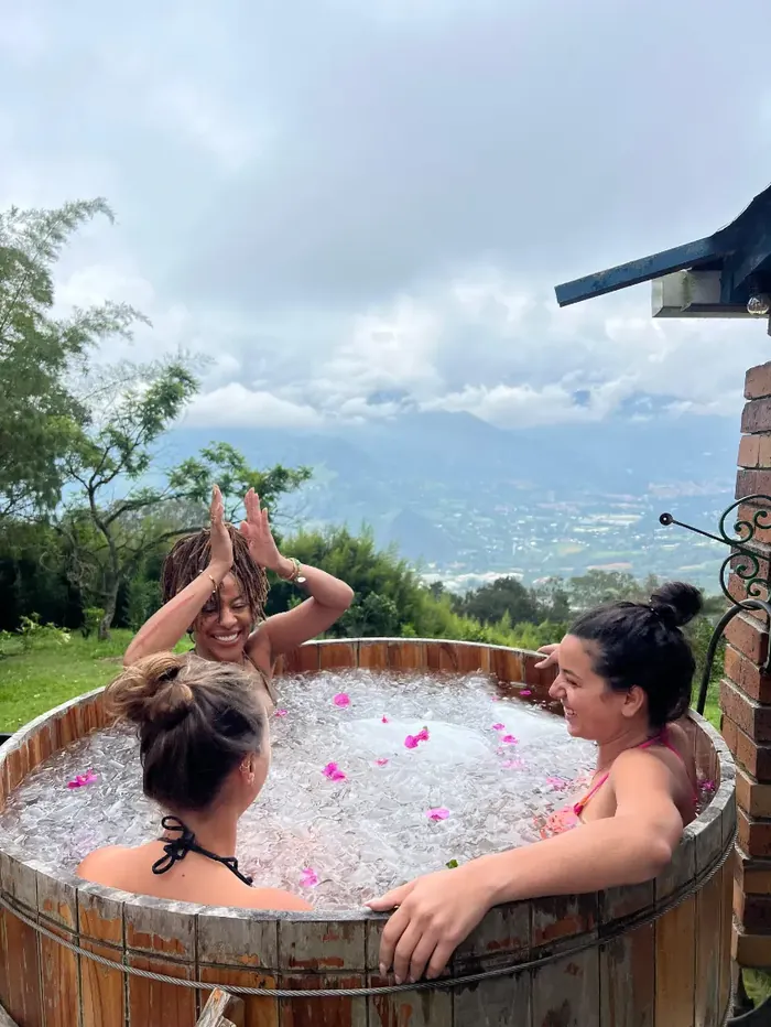 Harmonica Ayahuasca Retreat Colombia Ice bath celebration Two women raising their arms in the ice bath