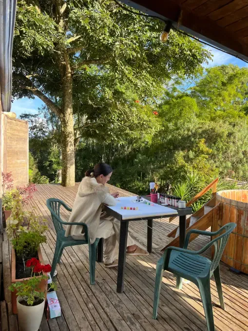 Harmonica Ayahuasca Retreat Colombia Journaling on the deck A participant journaling at a table on the deck