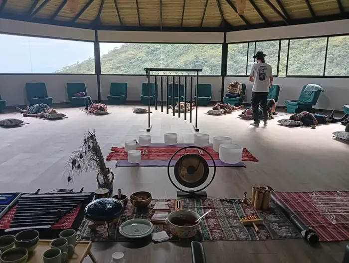Harmonica Ayahuasca Retreat Colombia Maloka sound healing setup The maloka set up for sound healing with mats, a gong and crystal bowls