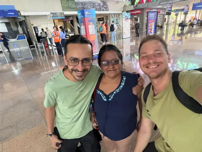 Harmonica Ayahuasca Retreat Colombia Meeting at the airport Three people smiling together for a selfie at the airport