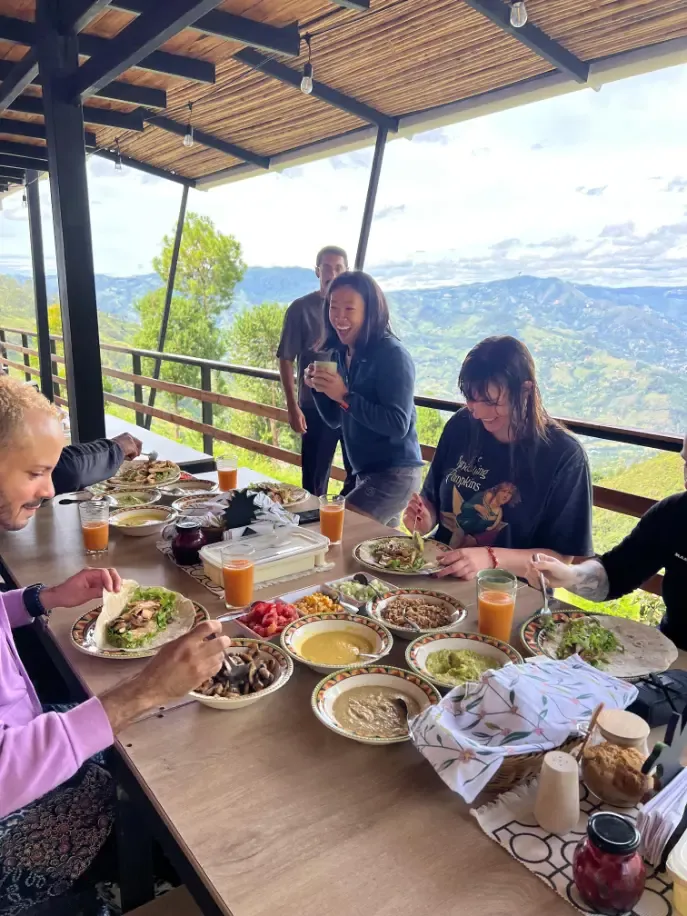 Harmonica Ayahuasca Retreat Colombia Shared terrace meal Participants sharing a meal at a table on the terrace